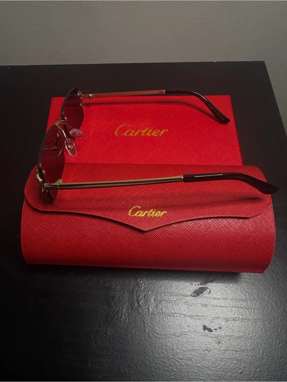 Cartier Women's Rimless Sunglasses with Burgundy Lenses and Gold Accents